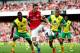 LONDON, ENGLAND - OCTOBER 19: Mesut Oezil of Arsenal is watched by Alexander Tettey (L) and Martin Olsson of Norwich City (R) during the Barclays Premier League match between Arsenal and Norwich City at Emirates Stadium on October 19, 2013 in London, Eng