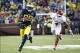 Oct 19, 2013; Ann Arbor, MI, USA; Michigan Wolverines quarterback Devin Gardner (98) runs the ball by Indiana Hoosiers linebacker Forisse Hardin (4) in the second half at Michigan Stadium. Michigan won 63-47. Mandatory Credit: Rick Osentoski-USA TODAY Spo