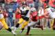 COLUMBUS, OH - OCTOBER 19: Noah Spence #8 of the Ohio State Buckeyes forces quarterback Jake Rudock #15 of the Iowa Hawkeyes out of the pocket in the second quarter at Ohio Stadium on October 19, 2013 in Columbus, Ohio. (Photo by Jamie Sabau/Getty Image