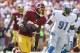 Sep 22, 2013; Landover, MD, USA; Washington Redskins wide receiver Pierre Garcon (88) runs with the ball in front of Detroit Lions defensive end Jason Jones (91) in the second quarter at FedEx Field. Mandatory Credit: Geoff Burke-USA TODAY Sports