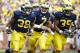Aug 31, 2013; Ann Arbor, MI, USA; Michigan Wolverines running back Thomas Rawls (38) quarterback Shane Morris (7) and fullback Sione Houma (39) celebrate a touchdown by Rawls second half against the Central Michigan Chippewas t Michigan Stadium. Mandatory