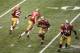 Feb 3, 2013; New Orleans, LA, USA; San Francisco 49ers quarterback Colin Kaepernick (7) hands the ball off to running back Frank Gore (21) as tackle Joe Staley (74) blocks and running back LaMichael James (23) runs the opposite direction during the second