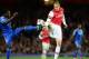 LONDON, ENGLAND - OCTOBER 29: Nicklas Bendtner of Arsenal beats Michael Essien of Chelsea to the ball during the Capital One Cup Fourth Round match between Arsenal and Chelsea at the Emirates Stadium on October 29, 2013 in London, England. (Photo by Jami