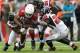 GLENDALE, AZ - OCTOBER 27: Wide receiver Larry Fitzgerald #11 of the Arizona Cardinals is tackled by cornerback Desmond Trufant #21, defensive end Jonathan Massaquoi #96 and free safety Thomas DeCoud #28 of the Atlanta Falcons after a reception during th