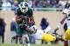 Nov 2, 2013; East Lansing, MI, USA; Michigan State Spartans running back Jeremy Langford (33) runs the ball against Michigan Wolverines linebacker Cameron Gordon (4) during the 2nd half of a game at Spartan Stadium. MSU won 29-6. Mandatory Credit: Mike Ca