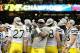 January 3, 2012; New Orleans, LA, USA; Michigan Wolverines players, including defensive end Frank Clark (57) with the trophy, celebrate their win over the Virginia Tech Hokies in the Sugar Bowl at the Mercedes-Benz Superdome. Mandatory Credit: Chuck Cook-