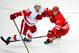 RALEIGH, NC - OCTOBER 04: Danny DeKeyser #65 of the Detroit Red Wings battles for a loose puck with Justin Faulk #27 of the Carolina Hurricanes during play at PNC Arena on October 4, 2013 in Raleigh, North Carolina. The Red Wings defeated the Hurricanes