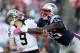 FOXBORO, MA - OCTOBER 13: Quarterback Drew Brees #9 of the New Orleans Saints gets off a pass while being hit by defensive end Chandler Jones #95 of the New England Patriots during the first half at Gillette Stadium on October 13, 2013 in Foxboro, Massach