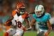 MIAMI GARDENS, FL - OCTOBER 31: A.J. Green #18 of the Cincinnati Bengals is forced out of bounds by Philip Wheeler #52 of the Miami Dolphins during a game at Sun Life Stadium on October 31, 2013 in Miami Gardens, Florida. (Photo by Mike Ehrmann/Getty Im