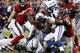 HOUSTON, TX - NOVEMBER 03: Trent Richardson #34 of the Indianapolis Colts is wrapped up by J.J. Watt #99 of the Houston Texans and Whitney Mercilus #59 at Reliant Stadium on November 3, 2013 in Houston, Texas. (Photo by Bob Levey/Getty Images)