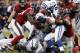 HOUSTON, TX - NOVEMBER 03: Trent Richardson #34 of the Indianapolis Colts is wrapped up by J.J. Watt #99 of the Houston Texans and Whitney Mercilus #59 at Reliant Stadium on November 3, 2013 in Houston, Texas. (Photo by Bob Levey/Getty Images)