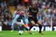 BIRMINGHAM, ENGLAND - SEPTEMBER 28: Manchester City player Vincent Kompany (r) holds off Villa player Karim El Ahmadi during the Barclays Premier League match between Aston Villa and Manchester City at Villa Park on September 28, 2013 in Birmingham, Engl