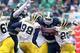 Nov 2, 2013; East Lansing, MI, USA; Michigan Wolverines quarterback Devin Gardner (98) is sacked by Michigan State Spartans defensive end Denzel Drone (42) and defensive end Marcus Rush (44) during the 1st half of a game at Spartan Stadium. Mandatory Cred