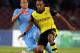 NAPLES, ITALY - SEPTEMBER 18: Pierre- Emerick Aubameyang (R) of Borussia Dortmund competes for the ball with Gokhan Inler of SSC Napoli during the Uefa Champions League Group F match between Napoli and Borussia Dortmund at Stadio San Paolo on September 18
