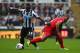 NEWCASTLE UPON TYNE, ENGLAND - OCTOBER 19: Cheik Ismael Tiote of Newcastle United and Glen Johnson of Liverpool battle for the ball during the Barclays Premier League match between Newcastle United and Liverpool at St James' Park on October 19, 2013 in N