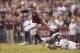 Nov 9, 2013; College Station, TX, USA; Texas A&M Aggies quarterback Johnny Manziel (2) breaks a tackle attempt by Mississippi State Bulldogs defensive back Jamerson Love (5) during the second quarter at Kyle Field. Mandatory Credit: Thomas Campbell-USA TO