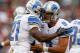 CLEVELAND, OH - OCTOBER 13: Quarterback Matthew Stafford #9 of the Detroit Lions celebrates a touchdown by running back Reggie Bush #21 against the Cleveland Browns at FirstEnergy Stadium on October 13, 2013 in Cleveland, Ohio. (Photo by Matt Sullivan/G