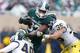EAST LANSING, MI - NOVEMBER 02: Desmond Morgan #48 and Joe Bolden #35 of the Michigan Wolverines bring down Jeremy Langford #33 of the Michigan State Spartans in the second quarter at Spartan Stadium on November 2, 2013 in East Lansing, Michigan. (Photo
