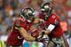 TAMPA, FL - NOVEMBER 11: Mike Glennon #8 of the Tampa Bay Buccaneers hands off to Brian Leonard #30 during a game against the Miami Dolphins at Raymond James Stadium on November 11, 2013 in Tampa, Florida. (Photo by Mike Ehrmann/Getty Images)