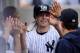 NEW YORK, NY - SEPTEMBER 21: Mark Reynolds #39 of the New York Yankees is congratulated by teammates after scoring a run in the third inning against the San Francisco Giants during interleague play on September 21, 2013 at Yankee Stadium in the Bronx bor