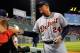 Oct 19, 2013; Boston, MA, USA; Detroit Tigers third baseman Miguel Cabrera (24) signs a baseball prior to game six of the American League Championship Series baseball game against the Boston Red Sox at Fenway Park. Mandatory Credit: Bob DeChiara-USA TODAY