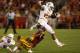AMES, IA - OCTOBER 3: Running back Malcolm Brown #28 of the Texas Longhorns jumps over linebacker Jared Brackens #14 of the Iowa State Cyclones as he rushes for yards in the first half of play at Jack Trice Stadium on October 3, 2013 in Ames, Iowa. (Phot