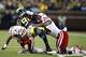 Nov 9, 2013; Ann Arbor, MI, USA; Michigan Wolverines quarterback Devin Gardner (98) is taken down by Nebraska Cornhuskers safety LeRoy Alexander (18) and defensive end Randy Gregory (44) in the second quarter at Michigan Stadium. Mandatory Credit: Rick Os