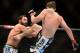 Mar 16, 2013; Montreal, Quebec, CAN; Carlos Condit (red) lands a kick to the body Johny Hendricks (blue) during their main card bout at UFC 158 at the Bell Centre. Mandatory Credit: Eric Bolte-USA TODAY Sports