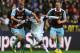 SWANSEA, WALES - OCTOBER 27: Jonathan de Guzman of Swansea City and Winston Reid of West Ham United in action during the Barclays Premier League match between Swansea City and West Ham United at Liberty Stadium on October 27, 2013 in Swansea, Wales. (Phot