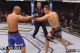 MacDonald attempts to jab, but no amount of speed or power is going to push the punch through Lawler's hand.