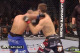 As MacDonald attempts to free his left hand and throw his right, Lawler slams a right hook into MacDonald's neck. A classic Lawler counter.