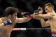 Jul 27, 2013; Seattle, WA, USA; Rory MacDonald (red tape) blocks a punch thrown by Jake Ellenberger (blue tape) during their welterweight bout at Key Arena. McDonald won by a decision. Mandatory Credit: Jayne Kamin-Oncea-USA TODAY Sports