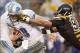 Nov 17, 2013; Pittsburgh, PA, USA; Detroit Lions quarterback Matthew Stafford (9) rushes the ball as Pittsburgh Steelers defensive end Cameron Heyward (97) defends during the fourth quarter at Heinz Field. The Pittsburgh Steelers won 37-27. Mandatory Cred
