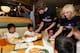 TORRANCE, CA - NOVEMBER 18: Pau Gasol, Nick Young and the Laker Girls serve Thanksgiving dinner to kids from the YMCA of West San Gabriel Valley and families from Pacific Clinics at Lucille's Smokehouse Bar-b-que on November 18, 2013 in Torrance, Califor