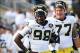 Oct 12, 2013; University Park, PA, USA; Michigan Wolverines quarterback Devin Gardner (98) and teammate Taylor Lewan (77) prior to the game against the Penn State Nittany Lions at Beaver Stadium. Penn State defeated Michigan 43-40 in overtime. Mandatory C