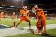 MIAMI GARDENS, FL - JANUARY 04: Tajh Boyd #10 of the Clemson Tigers celebrates with the Clemson mascot after he threw a 27-yard touchdown pass to Sammy Watkins #2 in the first quarter against the West Virginia Mountaineers during the Discover Orange Bowl