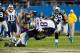 Nov 18, 2013; Charlotte, NC, USA; Carolina Panthers strong safety Robert Lester (38) tackles New England Patriots tight end Rob Gronkowski (87) during the fourth quarter at Bank of America Stadium. The Panthers defeated the Patriots 24-20. Mandatory Credi