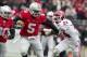 Nov 23, 2013; Columbus, OH, USA; Ohio State Buckeyes quarterback Braxton Miller (5) breaks a tackle by Indiana Hoosiers cornerback Tim Bennett (24) in the first quarter of the game at Ohio Stadium. Mandatory Credit: Trevor Ruszkowksi-USA TODAY Sports