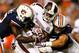 AUBURN, AL - SEPTEMBER 14: Robenson Therezie #27 and Jake Holland #5 of the Auburn Tigers tackle LaDarius Perkins #27 of the Mississippi State Bulldogs at Jordan-Hare Stadium on September 14, 2013 in Auburn, Alabama. (Photo by Kevin C. Cox/Getty Images)