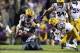 Nov 23, 2013; Baton Rouge, LA, USA; Texas A&M Aggies quarterback Johnny Manziel (2) is tackled by LSU Tigers linebacker Lamin Barrow (18) in the second half at Tiger Stadium. LSU defeated Texas A&M 34-10. Mandatory Credit: Crystal LoGiudice-USA TODAY Spor