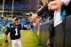 CHARLOTTE, NC - NOVEMBER 18: Cam Newton #1 of the Carolina Panthers celebrates with fans after a win over the New England Patriots at Bank of America Stadium on November 18, 2013 in Charlotte, North Carolina. The Panthers won 24-20. (Photo by Grant Halv