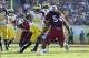 January 1,2013; Tampa, FL, USA; Michigan Wolverines quarterback Devin Gardner (12) runs with the ball as South Carolina Gamecocks defensive end Jadeveon Clowney (7) and linebacker Shaq Wilson (54) defend during the second half of the 2013 Outback Bowl at