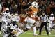 Nov 28, 2013; Austin, TX, USA; Texas Longhorns tailback Joe Bergeron (24) avoids a tackle by Texas Tech Red Raiders linebacker Sam Eguavoen (13)during the first quarter at Darrell K Royal-Texas Memorial Stadium. Mandatory Credit: Brendan Maloney-USA TODAY