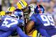 EAST RUTHERFORD, NJ - NOVEMBER 17: Eddie Lacy #27 of the Green Bay Packers is tackled by Jacquian Williams #57 and Cullen Jenkins #99 of the New York Giants at MetLife Stadium on November 17, 2013 in East Rutherford, New Jersey.The New York Giants defe