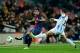BARCELONA, SPAIN - JANUARY 16: Martin Montoya of Barcelona FC competes for the ball with Sebastian B. Fernandez of Malaga CF during the Copa del Rey Quarter Final match between Barcelona FC and Malaga CF at Camp Nou on January 16, 2013 in Barcelona, Spain