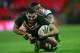 LONDON, ENGLAND - NOVEMBER 23: Greg Inglis of Australia is tackled by Eloni Vunakece of Fiji during the Rugby League World Cup Semi Final match between Australia and Fiji at Wembley Stadium on November 23, 2013 in London, England. (Photo by Jamie McDona