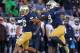 SOUTH BEND, IN - NOVEMBER 02: Eilar Hardy #16 (L) and Jaylon Smith #9 of the Notre Dame Fighting Irish celebrate a sack against the Navy Midshipmen at Notre Dame Stadium on November 2, 2013 in South Bend, Indiana. Notre Dame defeated Navy 38-34. (Photo