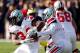 ANN ARBOR, MI - NOVEMBER 30: Quarterback Braxton Miller #5 hands the ball off to running back Carlos Hyde #34 of the Ohio State Buckeyes against the Michigan Wolverines during a game at Michigan Stadium on November 30, 2013 in Ann Arbor, Michigan. (Photo