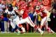 KANSAS CITY, MO - DECEMBER 01: Quarterback Alex Smith #11 of the Kansas City Chiefs scrambles as defensive tackle Terrance Knighton #94 of the Denver Broncos chases during the game at Arrowhead Stadium on December 1, 2013 in Kansas City, Missouri. (Phot