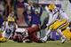 After Dwayne Thomas (left) sacked and stripped Brandon Allen (center), Jermauria Rasco (right) stretches to recover a fumble that sealed the deal for LSU.